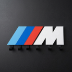 M logo key holder flat lay showing blue red white design and 6 black hooks